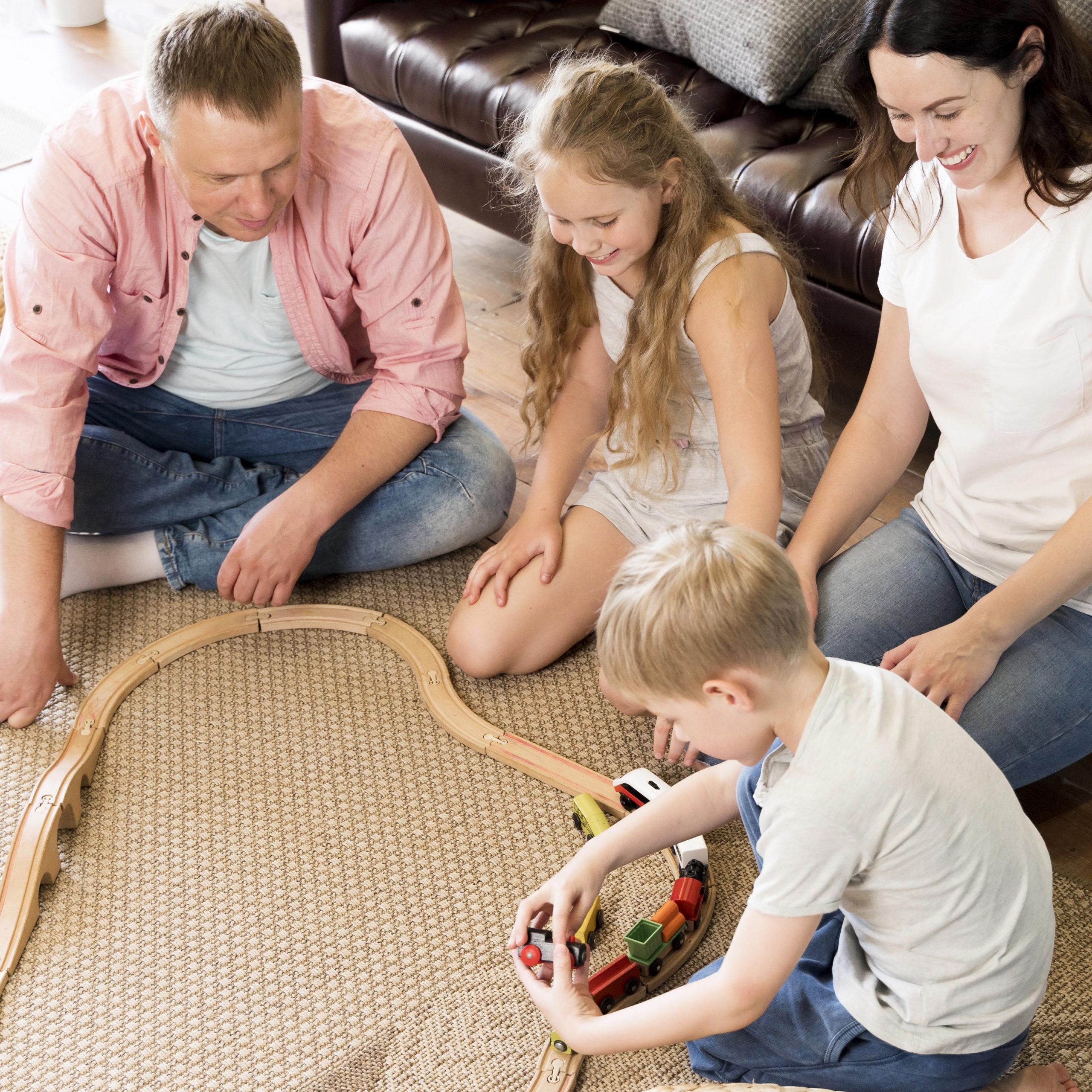 high-angle-family-playing-with-train