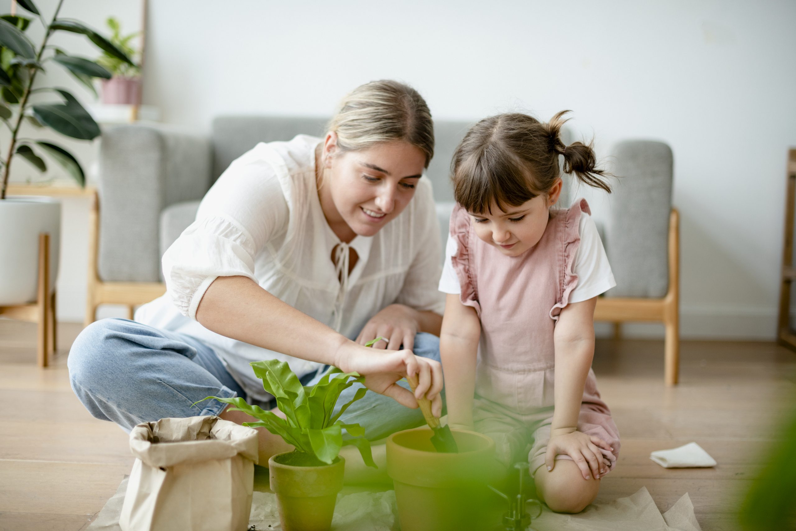 Kid potting plant at home as a hobby